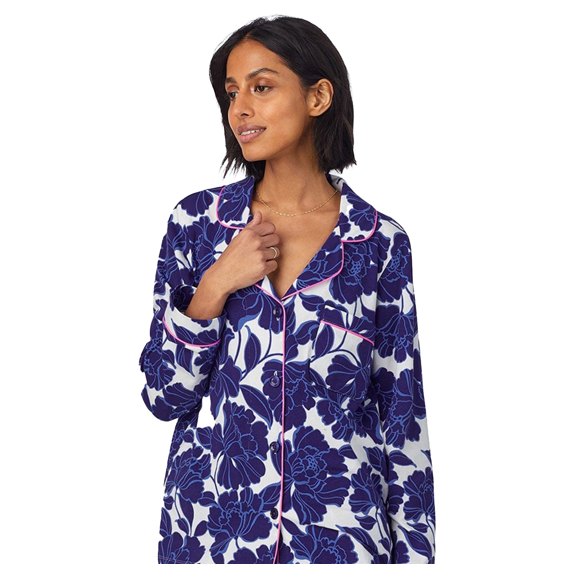 Close-up of the pajama top featuring a navy floral print with pink piping and button-up front.