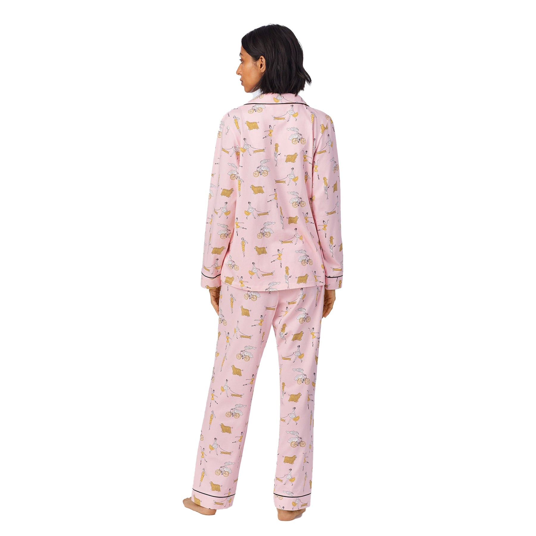 Back view of slim model wearing the pink pajama set, highlighting the full print and tailored cuffs.