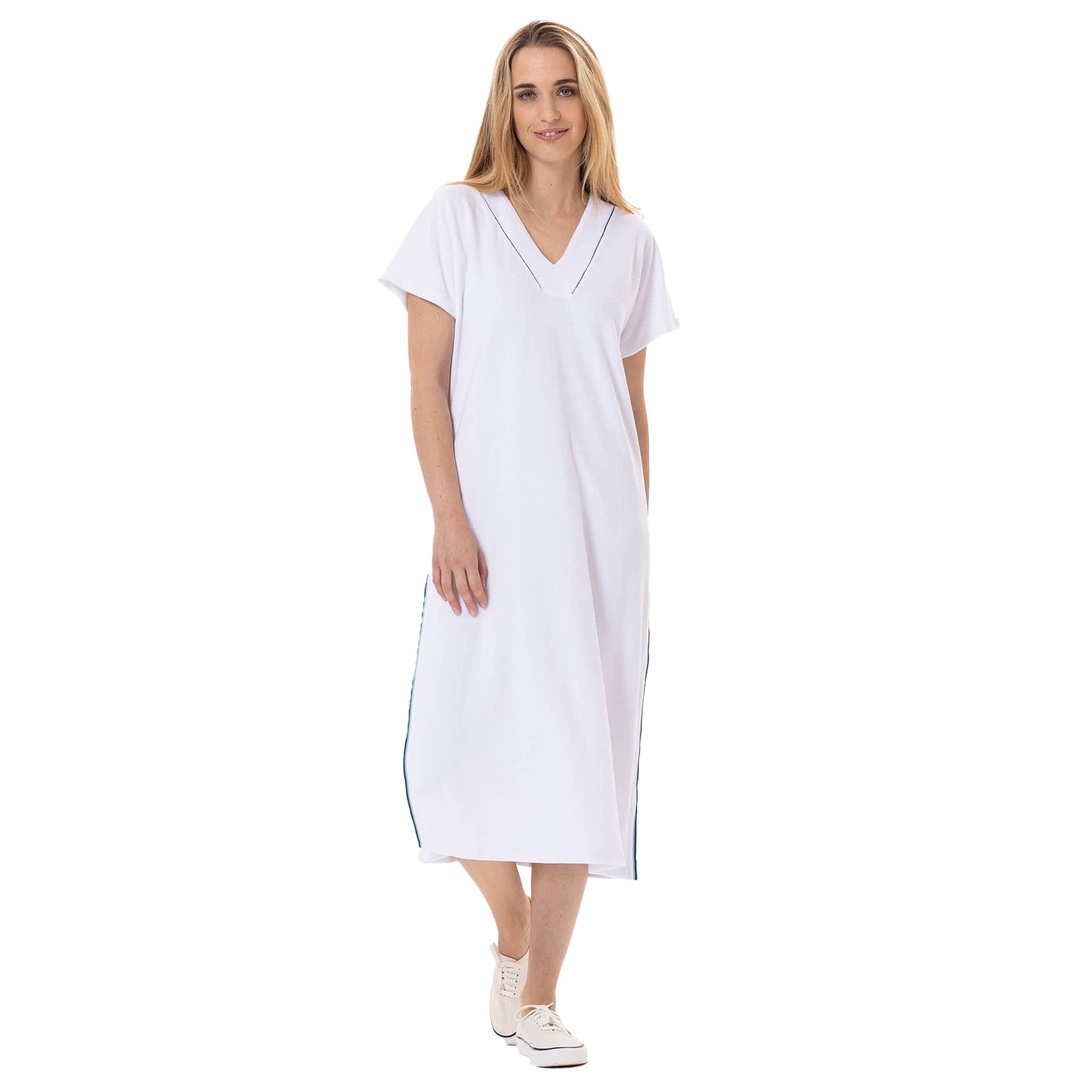 Woman wearing a white midi terry dress with short sleeves and V-neck, standing with a relaxed expression.