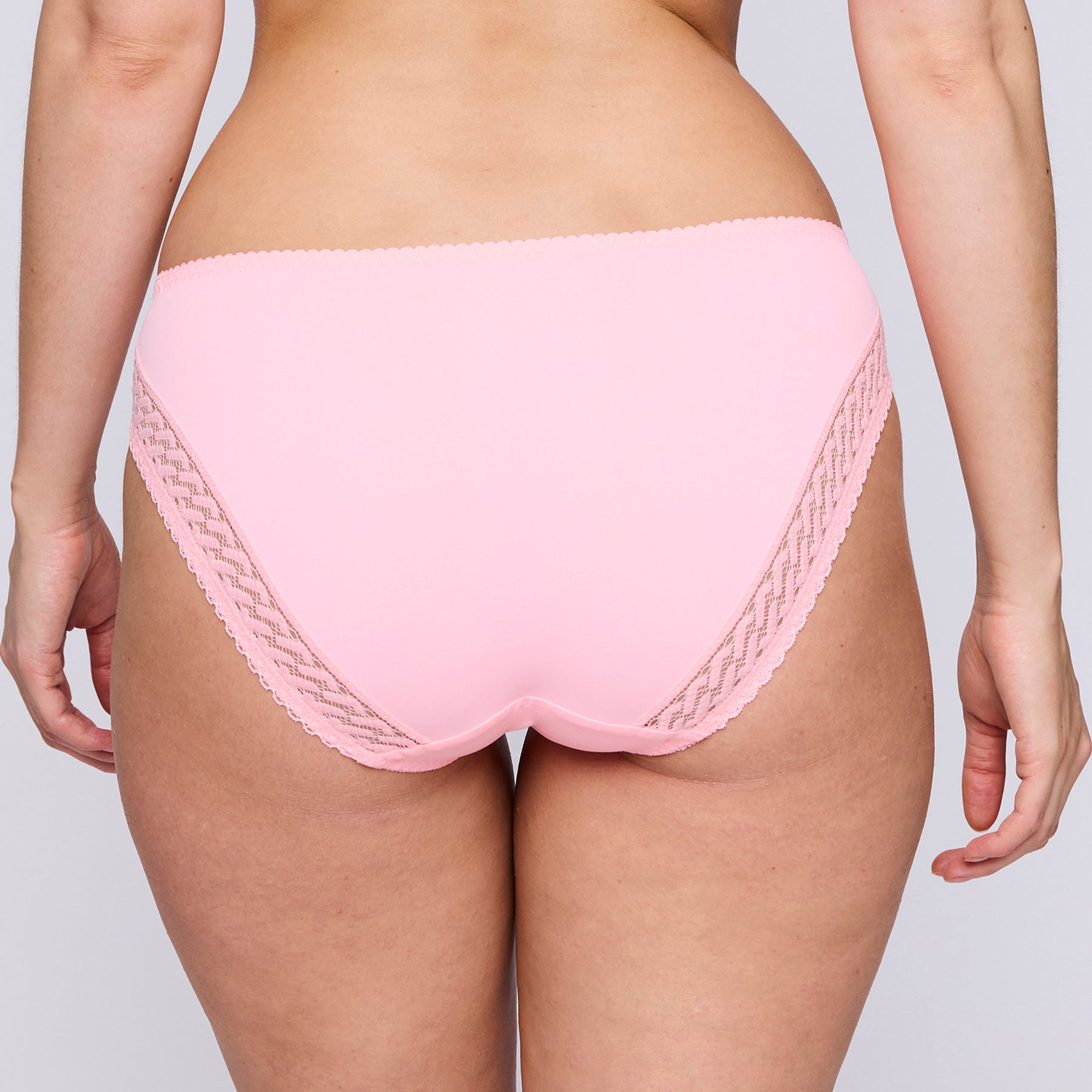 Back view on model of PrimaDonna Montara Rio brief in Pink Parfait, smooth fabric with lace side detail.