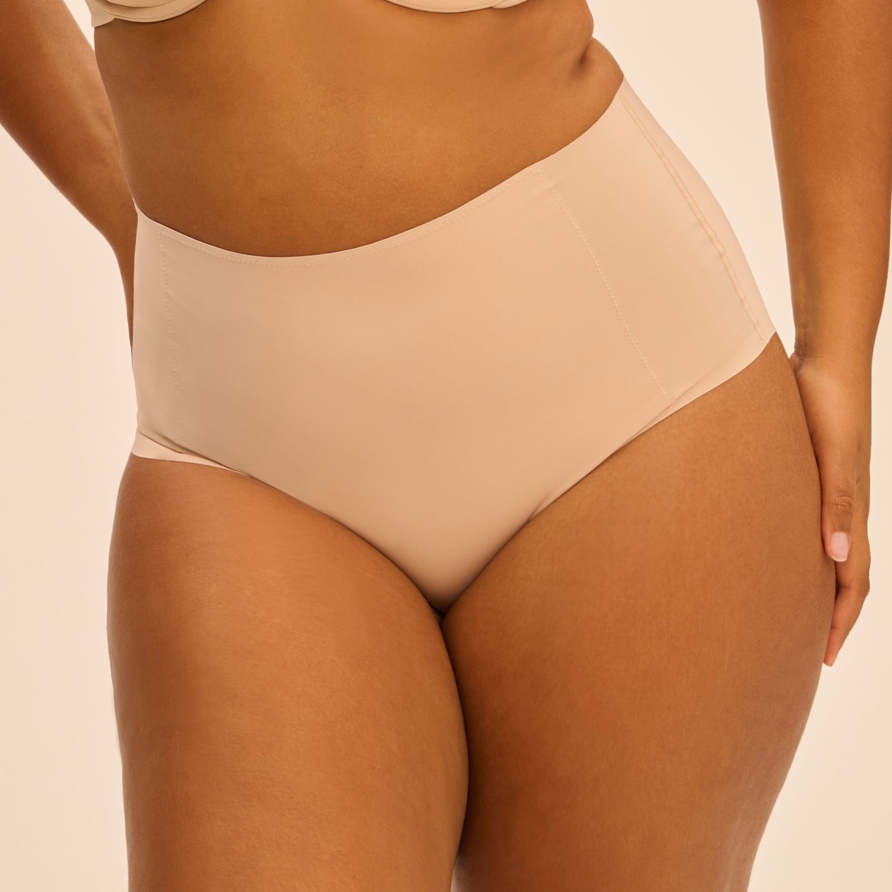 Front view of Peau Rosée control brief on curvy model.