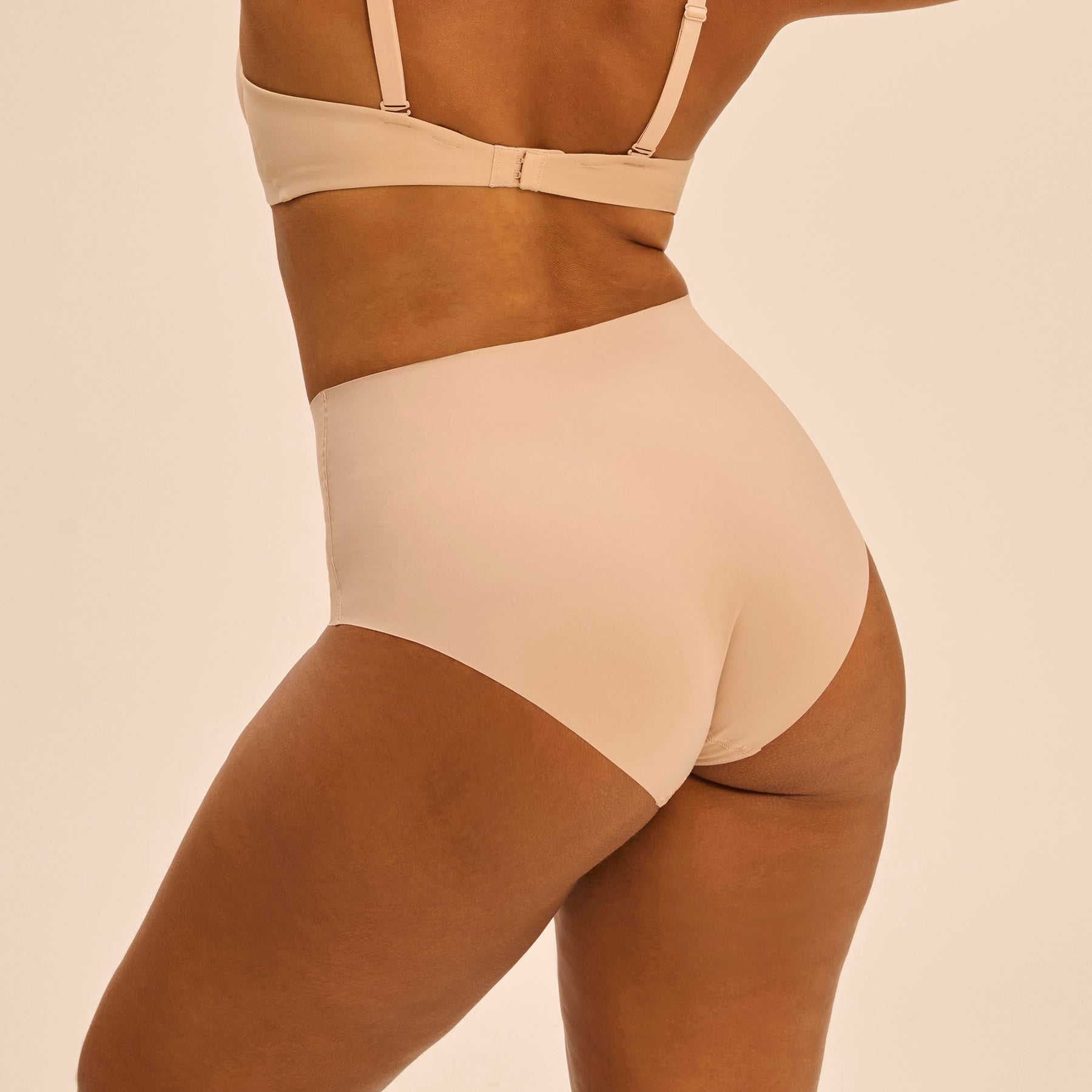 Back view of high-waisted control brief in Peau Rosée on model.
