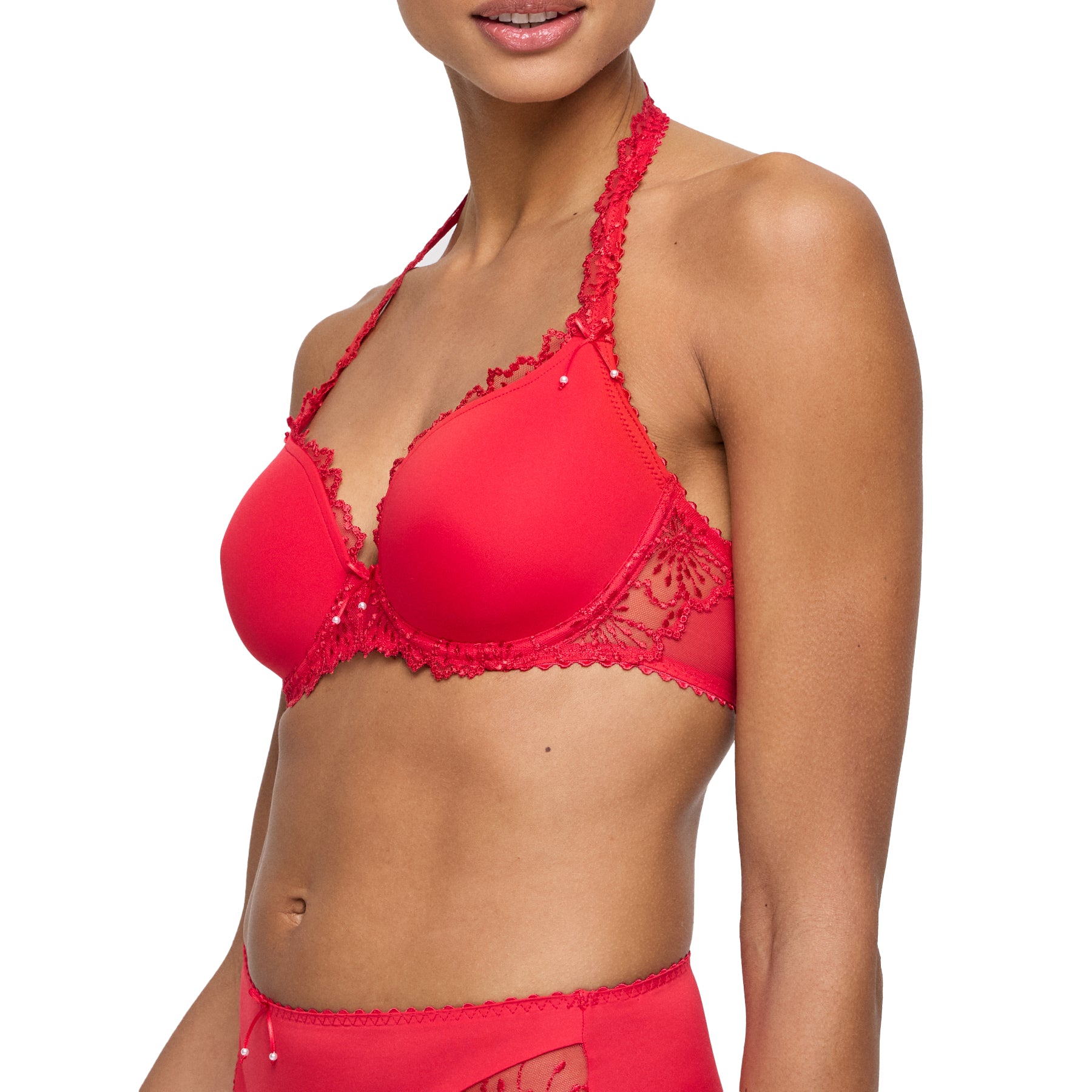 Side view of model in red padded bra with embroidered lace side panel and halter neckline.