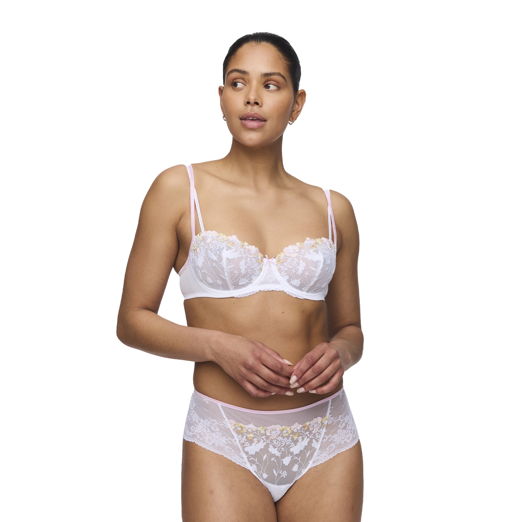 A model wearing a matching embroidered balconette bra and high-waisted lace panty, standing against a plain background, showcasing the elegant lingerie set.