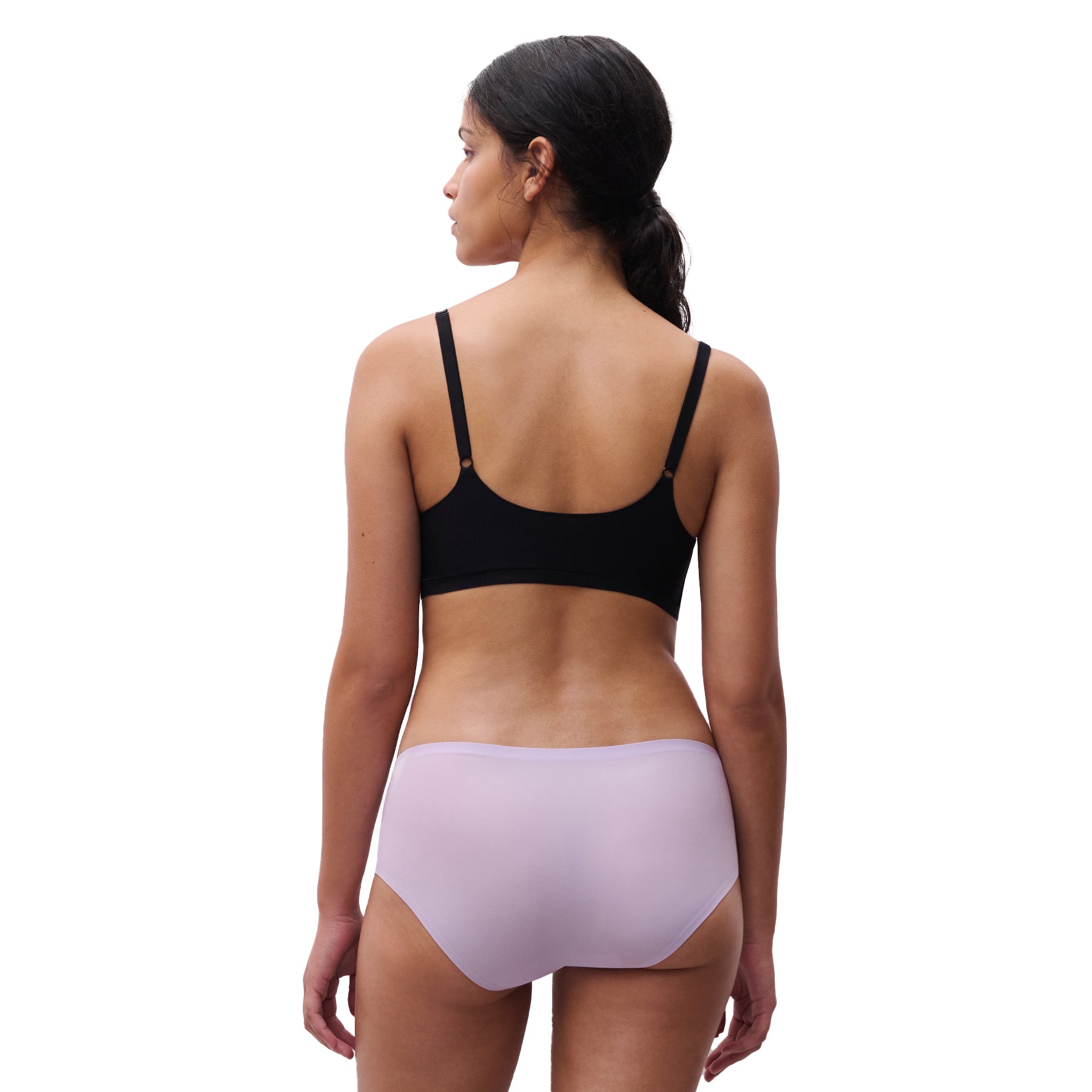 A model wearing a lavender Shorty in purple colour from Chantelle on the white background, back view.