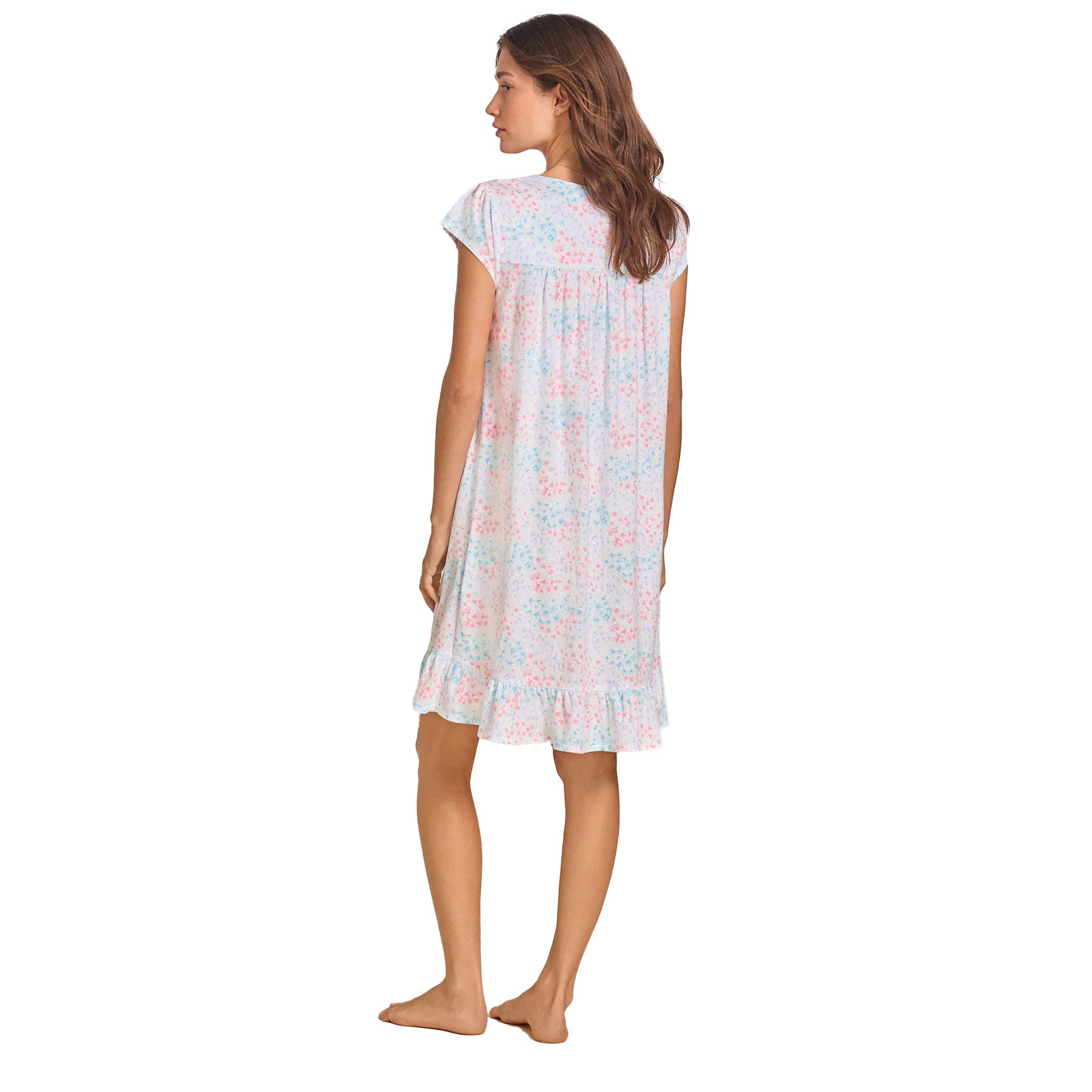 A rear view of the model in the floral nightgown, highlighting the gently gathered back and flowy silhouette.