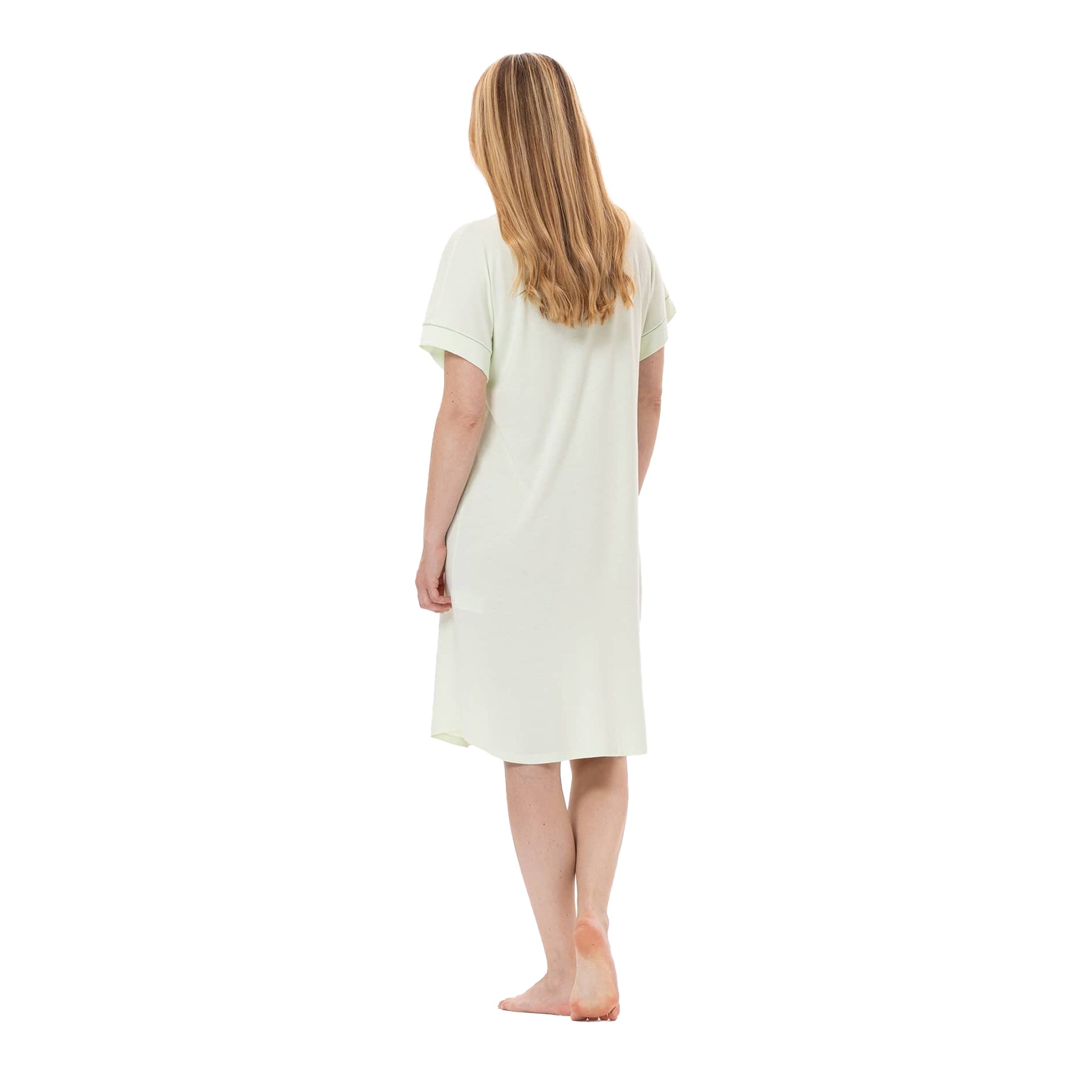 Back view of a woman in a light green short-sleeve nightgown, showing its relaxed fit and knee-length hemline.