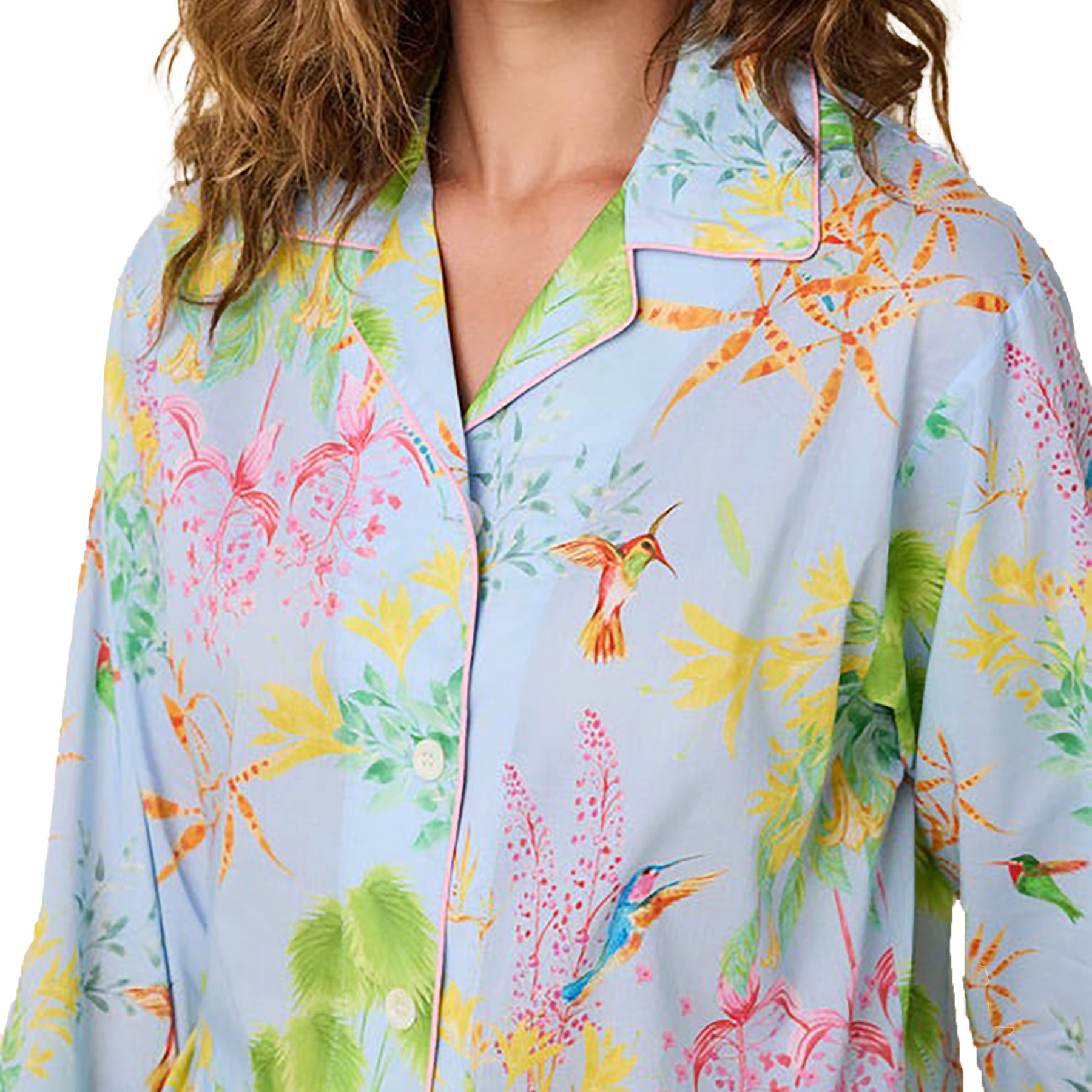 long sleeve button up pajamas with matching long pants in a multicolour hummingbird print on a blue background. Closeup front on model.