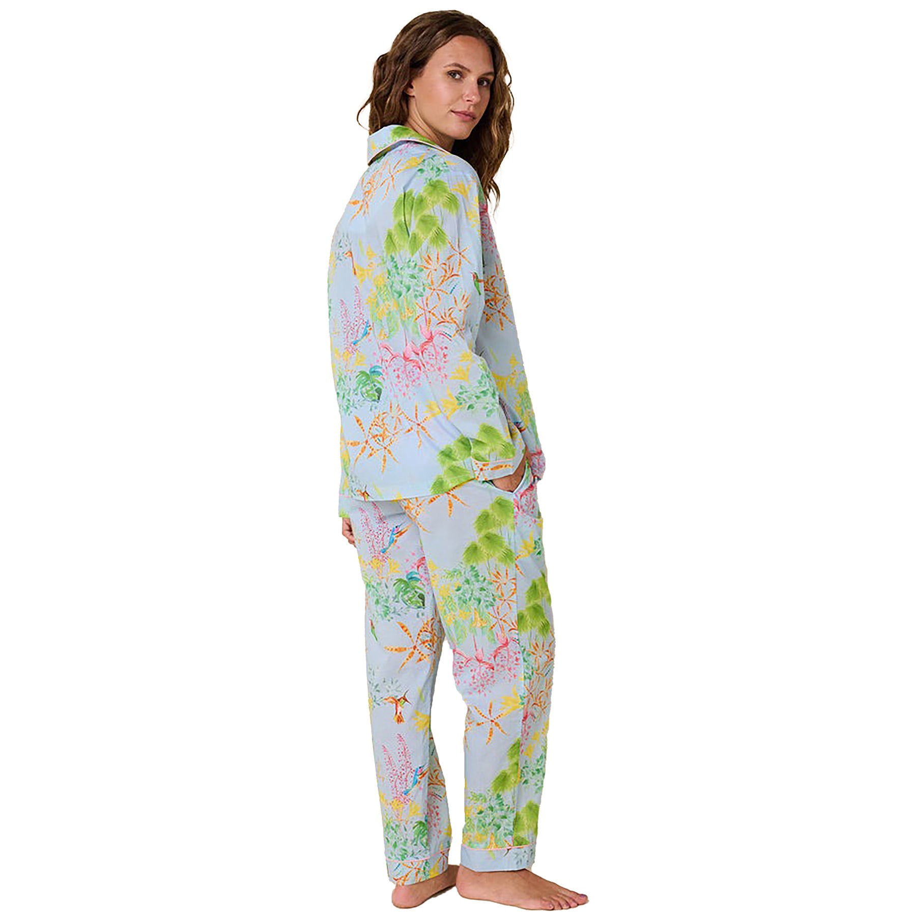 long sleeve button up pajamas with matching long pants in a multicolour hummingbird print on a blue background. Rear view on model.