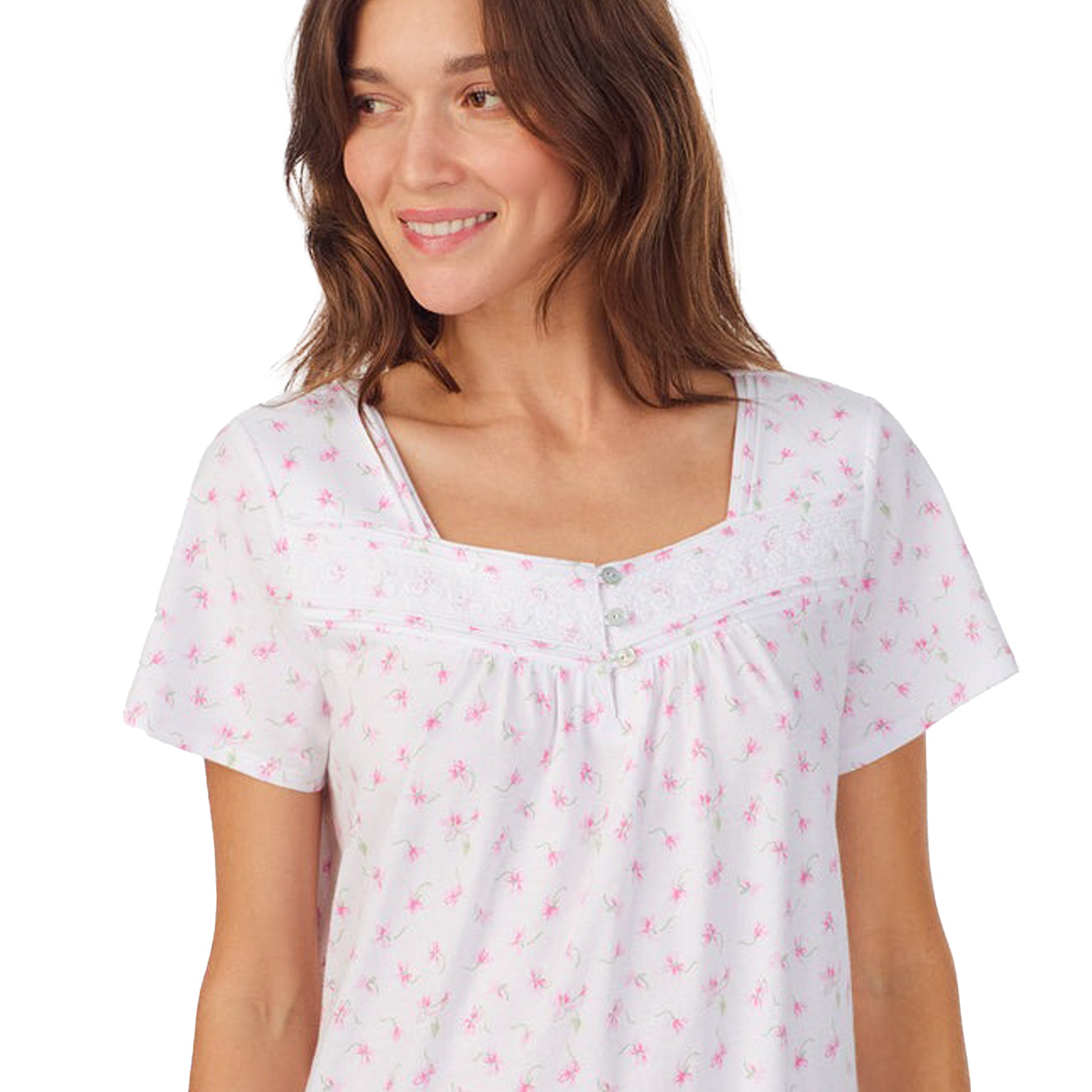 Front/close-up view of a women's floral nightshirt in a "petite pink floral" print showcasing intricate lace trim and button detailing, fashion photoshoot.