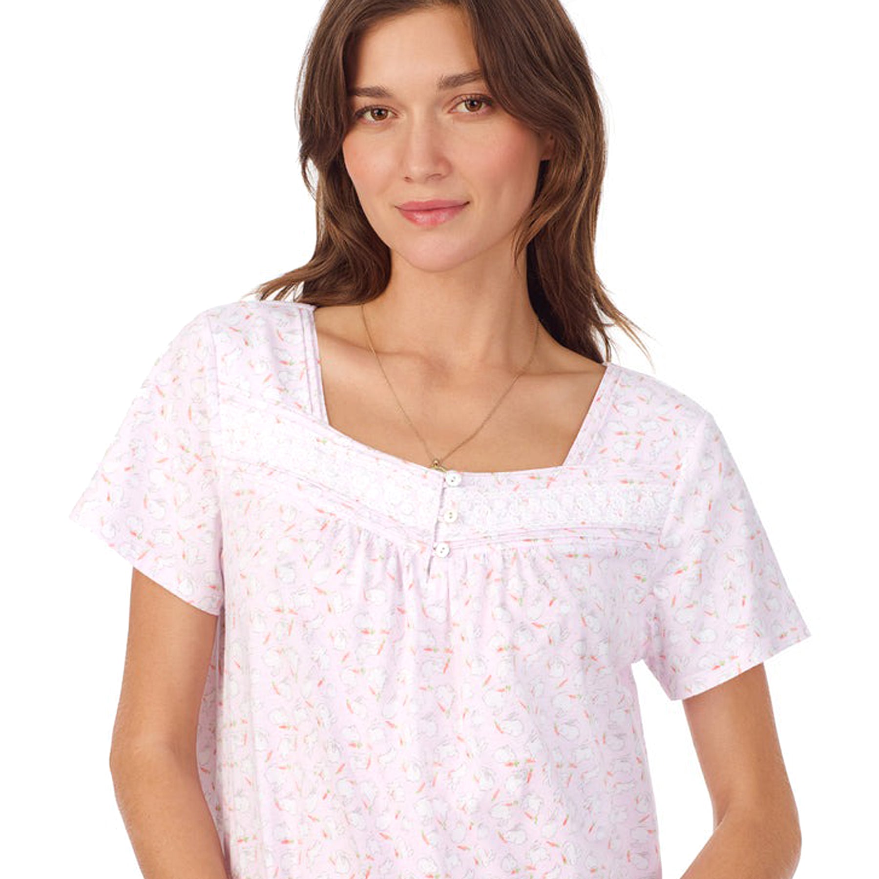 Front/close-up view of a women's floral nightshirt in a "sweet bunny" print showcasing intricate lace trim and button detailing, fashion photoshoot.