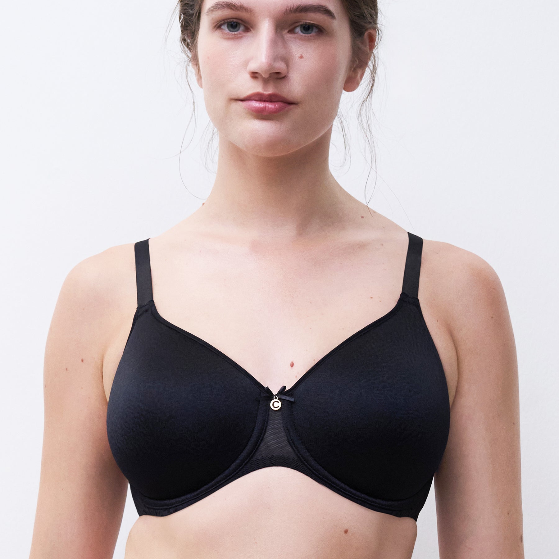 Chantelle molded full cup underwired spacer bra in black. Front view on model.