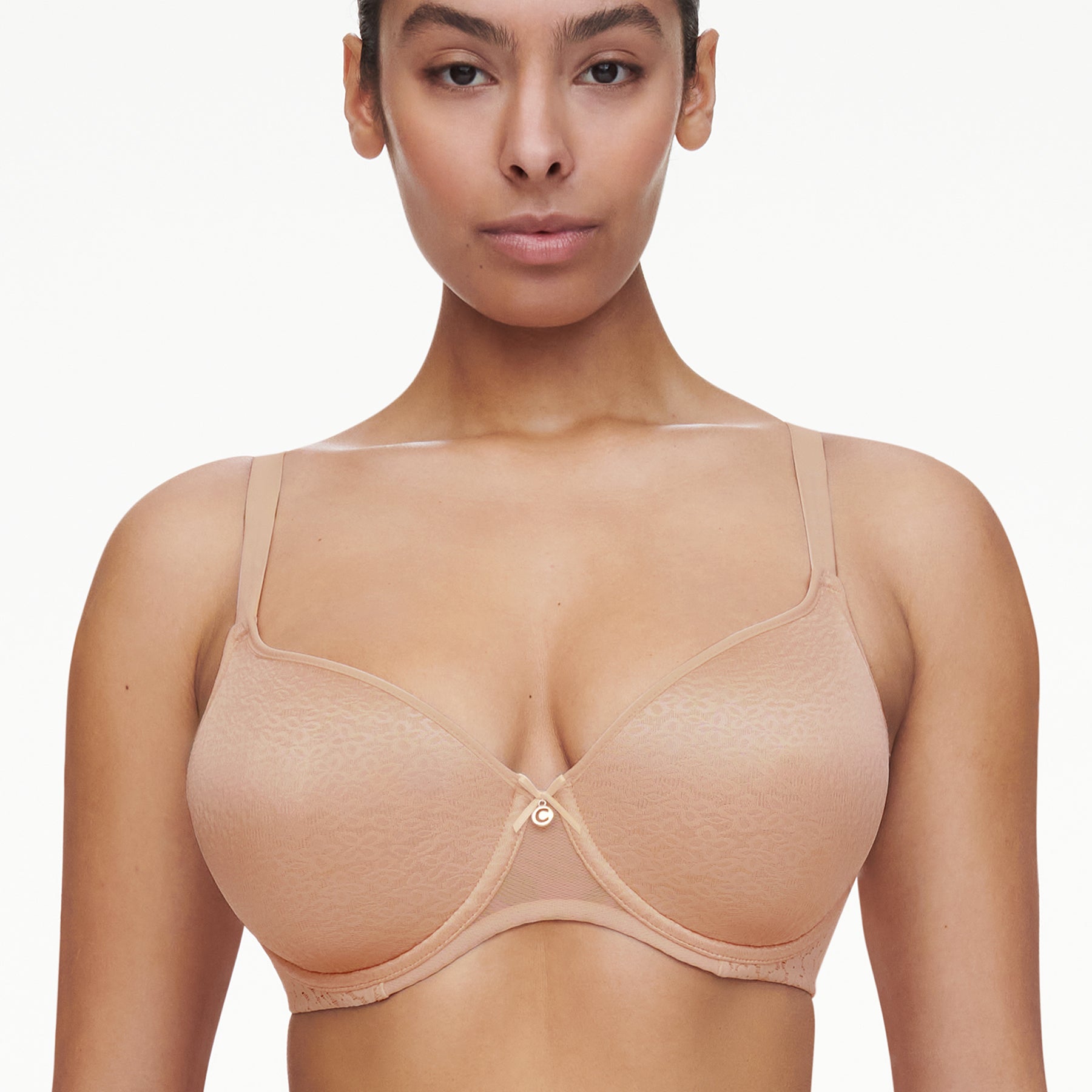 Chantelle molded full cup underwired spacer bra in nude golden beige. Front view on model.