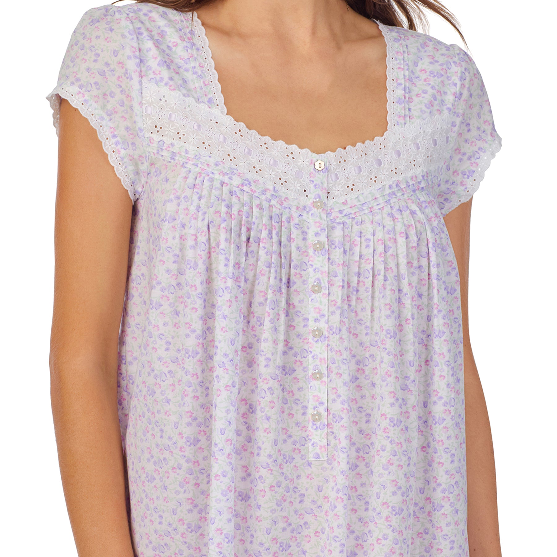 Close-up view of a women's floral nightshirt in a white garden daisy print, showcasing intricate lace trim, button detailing, and cap sleeves.