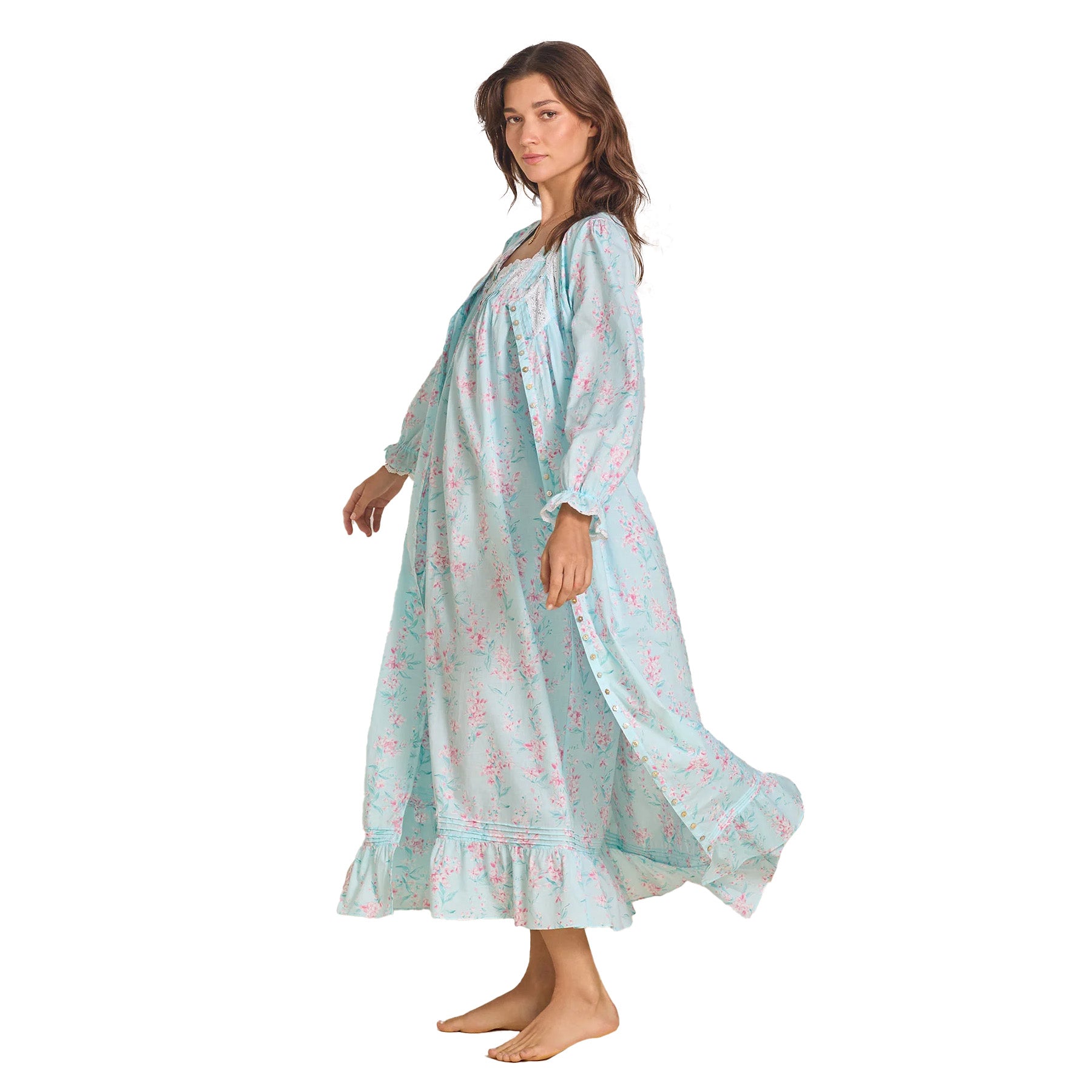 The same model in the long nightgown, gently lifting the hem to show the airy movement of the fabric.