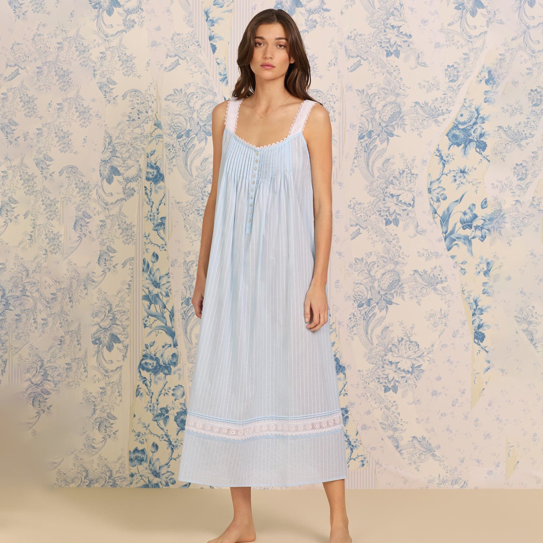 Front view of a women's floral nightshirt in a cottage blue, showcasing intricate lace trim, button detailing.