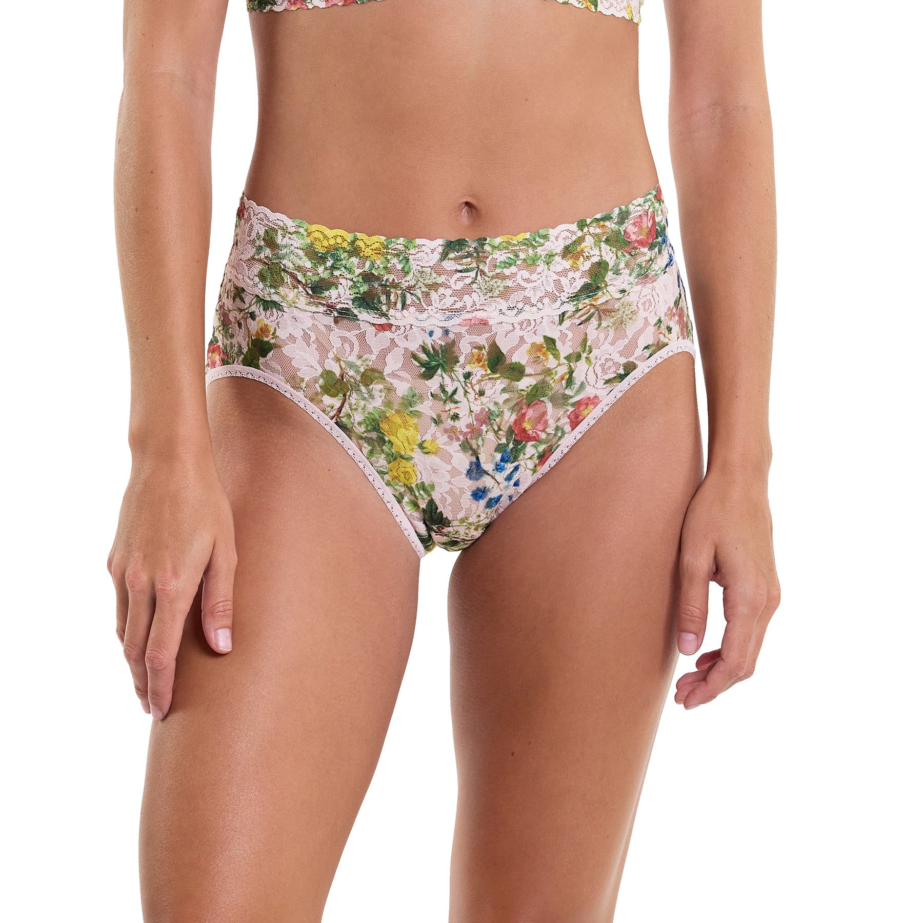 Printed lace high waist french cut full brief in pink, green and blue florals on a light pink background, front view on model.