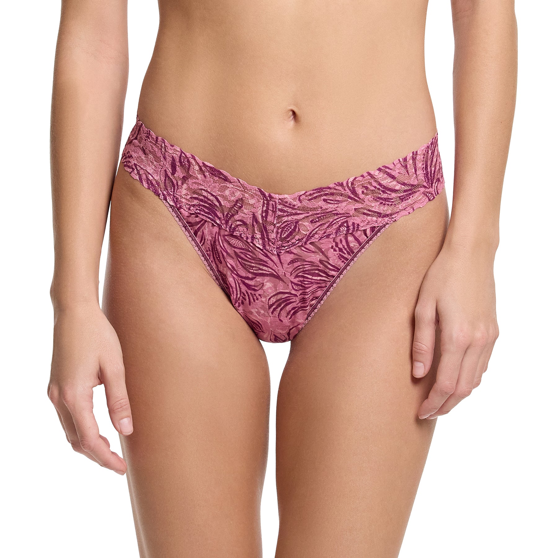 Woman wearing Hanky Panky Original Rise Thong in In The Jungle – botanical print lace thong in pink and plum hues with V-front low-rise cut.