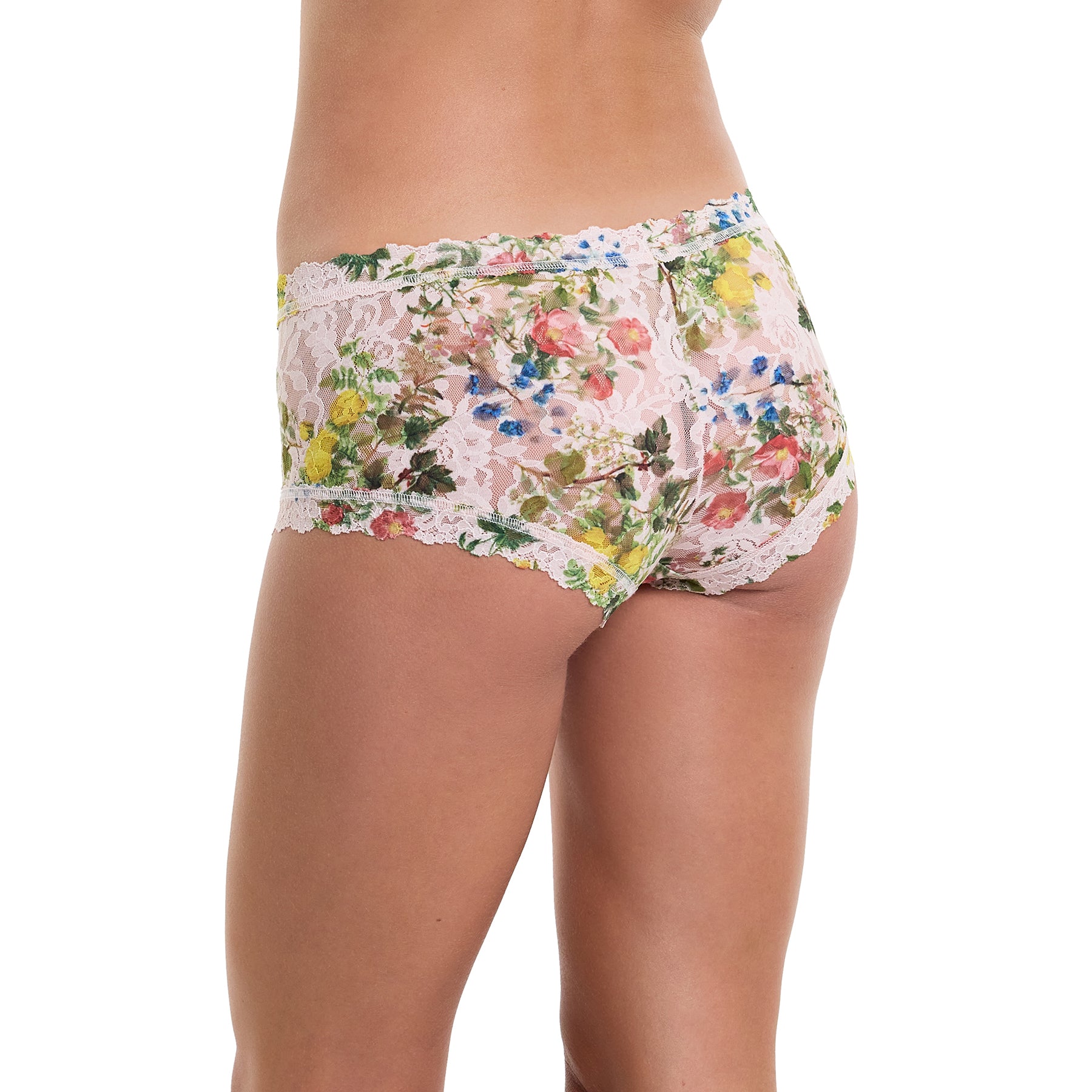 Printed lace boyshort in pink, green and blue florals on a light pink background. Rear view on model.