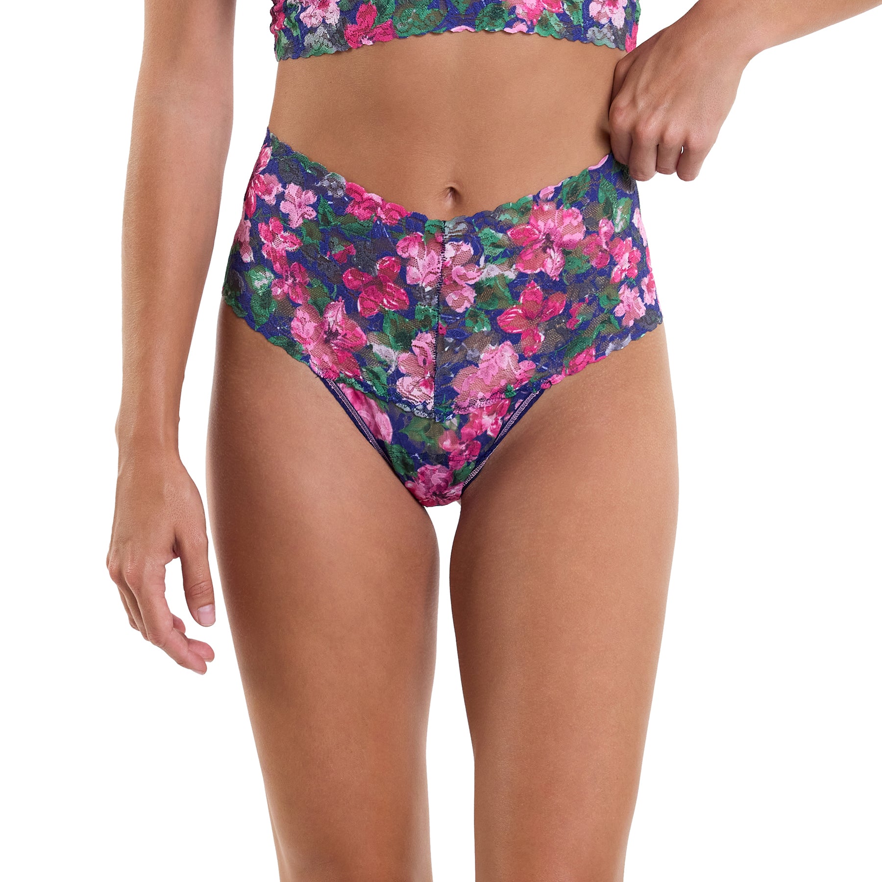 Wide band printed lace high rise thong with pink and green florals on a navy background. Front view on model.