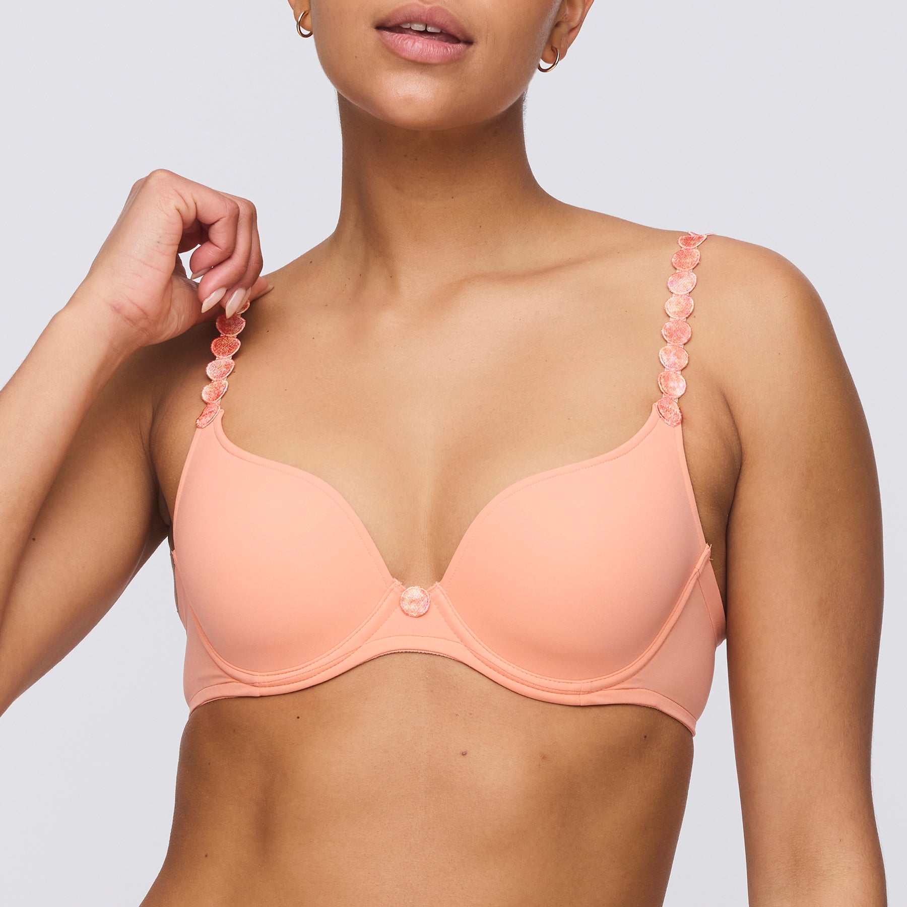 Seamless padded plunge heart shaped bra in papaya smoothie orange peach. Front view on model.