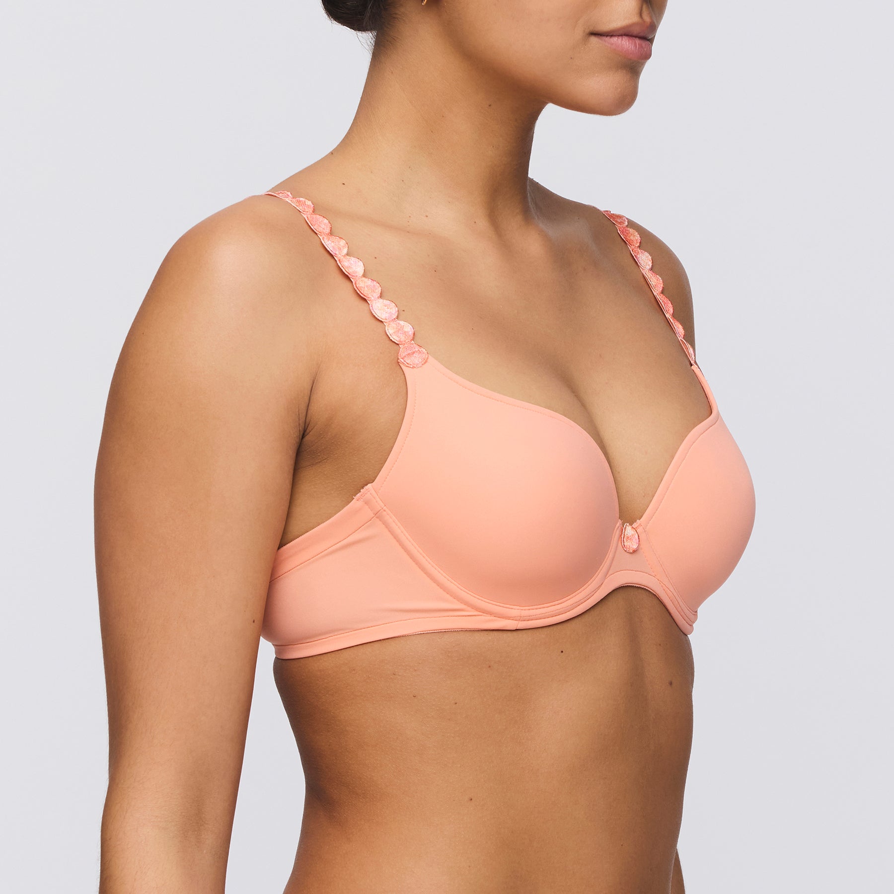 Seamless padded plunge heart shaped bra in papaya smoothie orange peach. Side view close up on model.