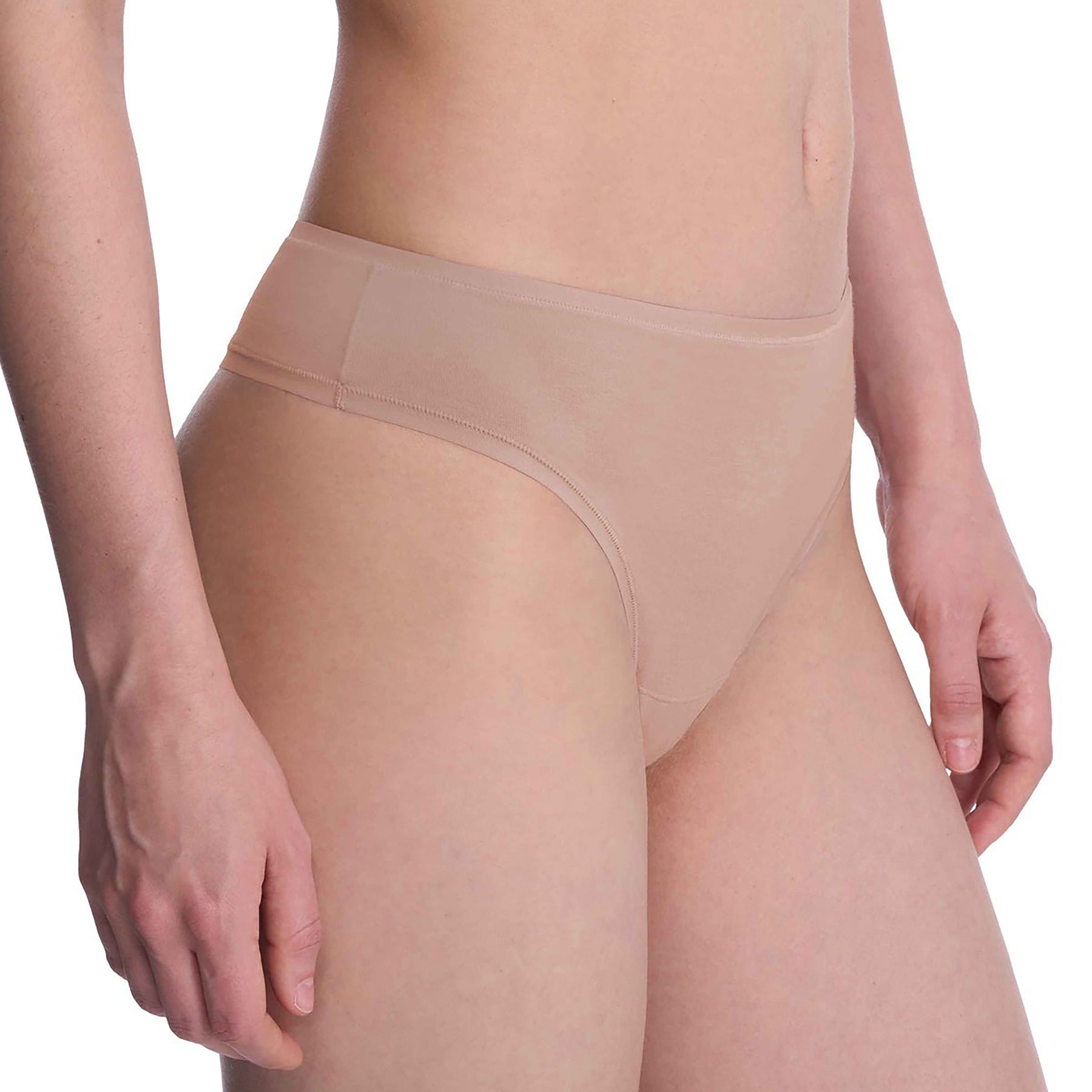 Seamless pima cotton mid-rise thong in cafe nude. Side view close up on model.