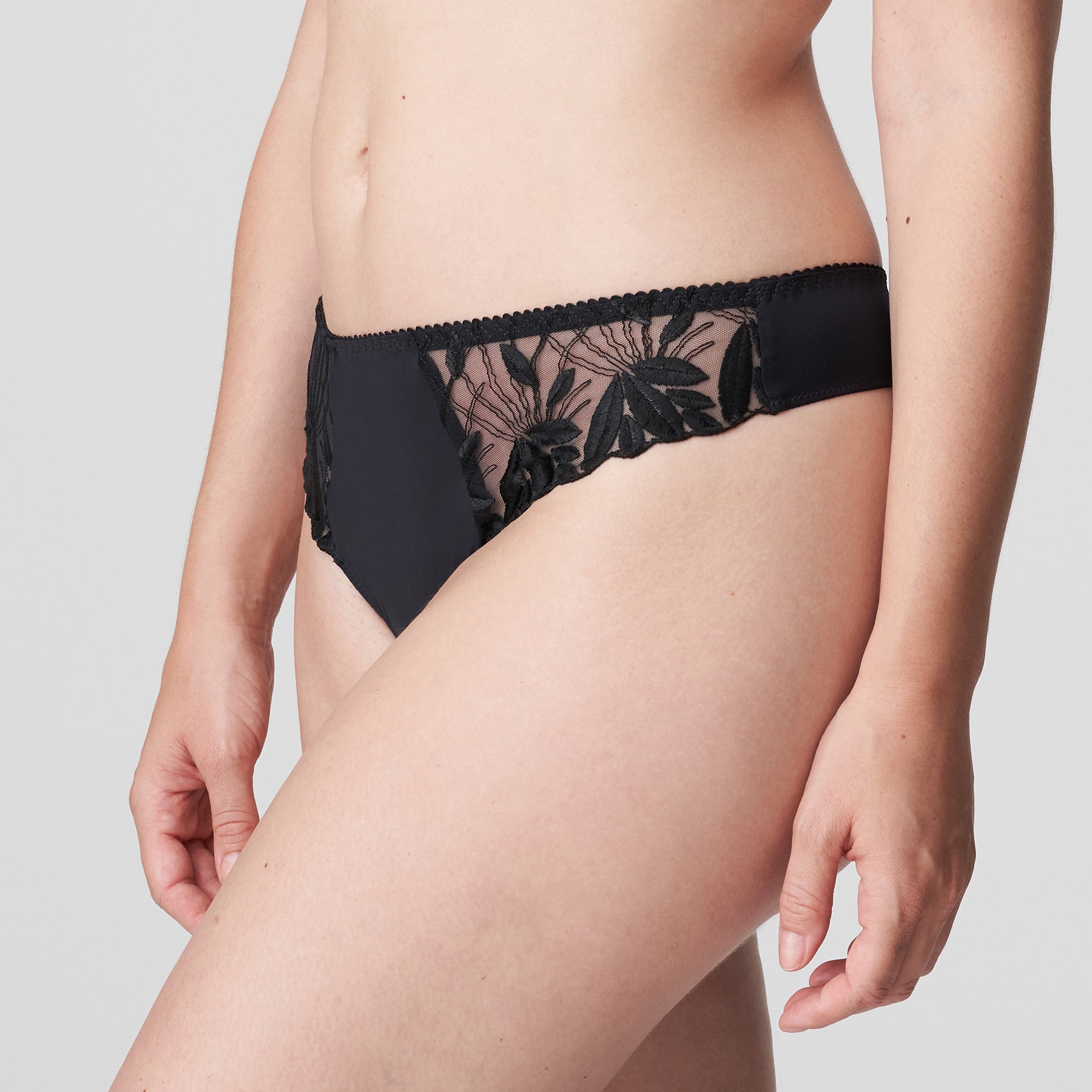 PrimaDonna Orlando charcoal grey thong with embroidery at the hips. Side view on model.