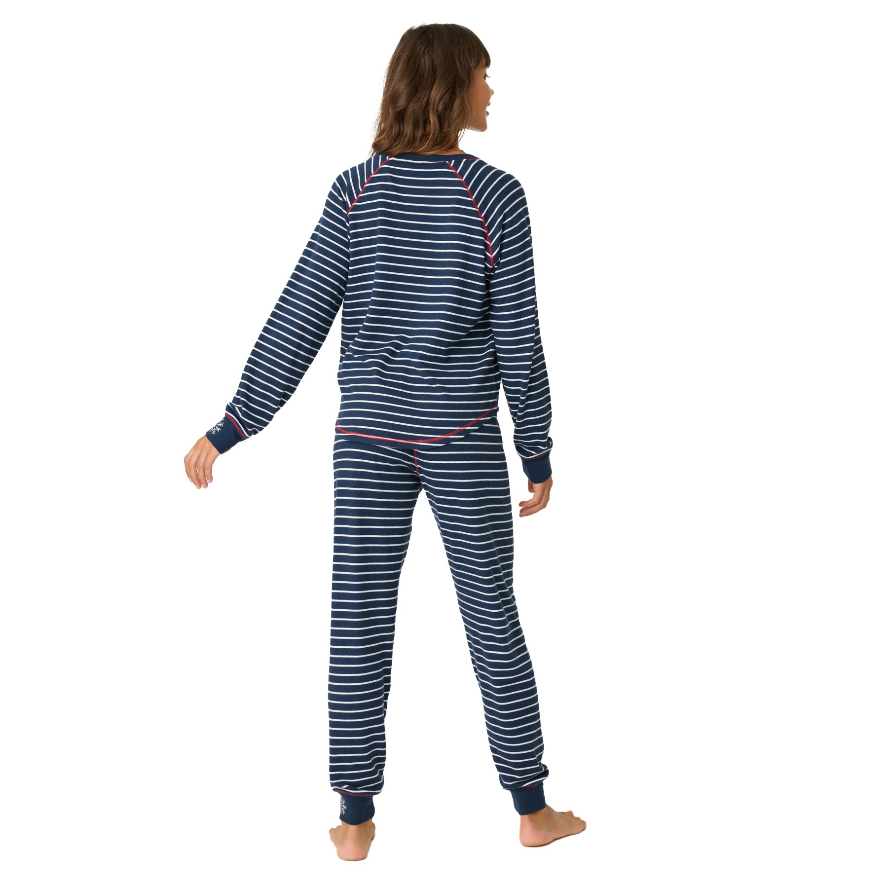 A model wearing a striped printed pajamas looking away from the camera.