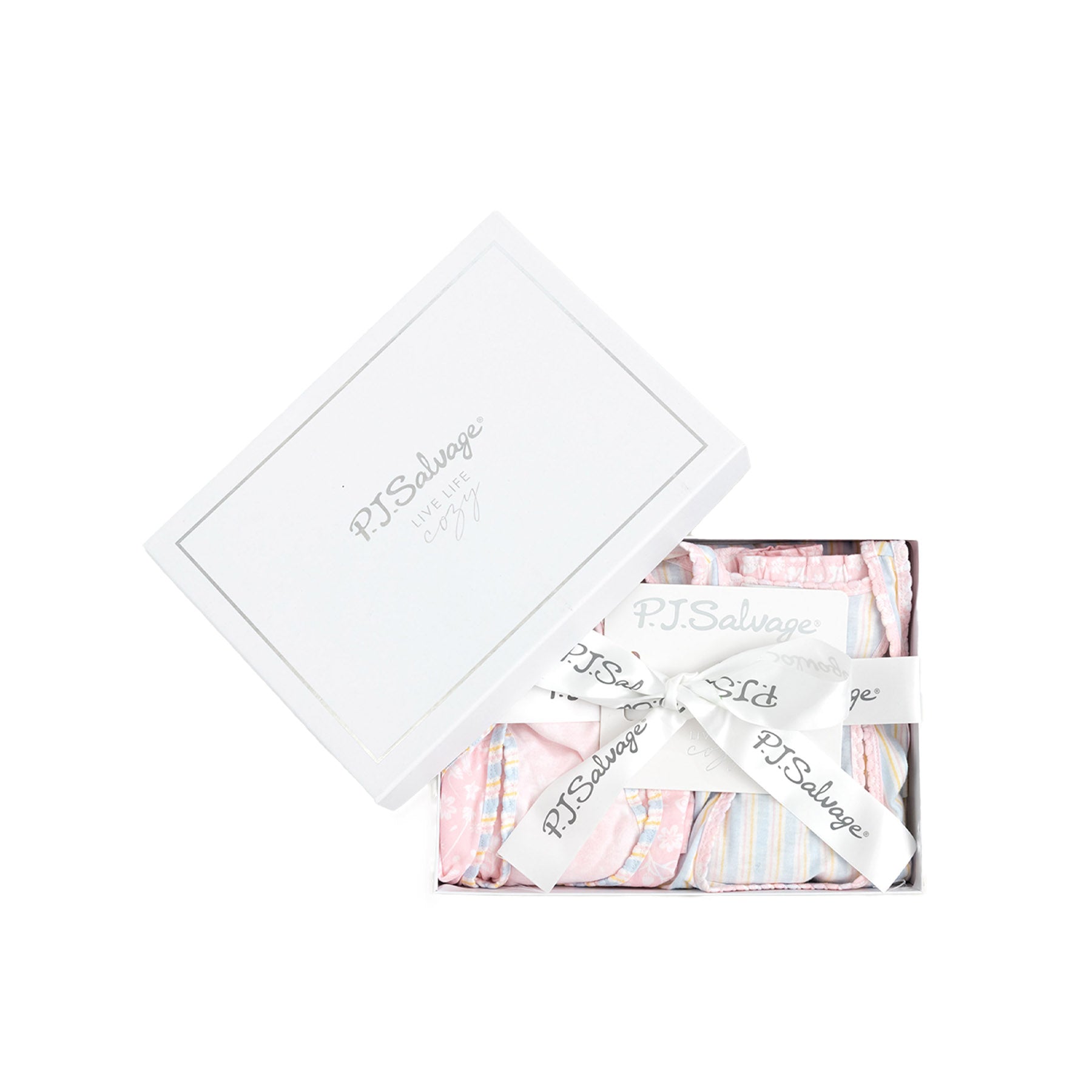 A white gift box labeled "P.J. Salvage" with a ribbon, containing pastel pink and striped pajama sets.