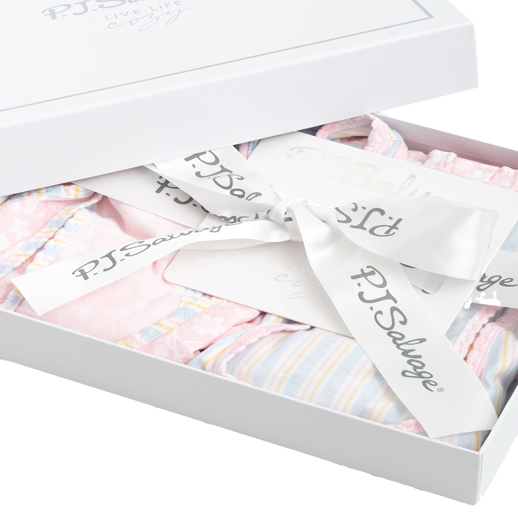 A close-up of the "P.J. Salvage" gift box, showing delicate packaging with a white ribbon.