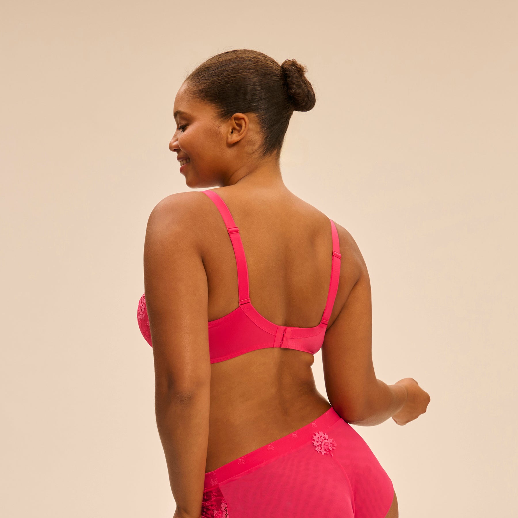 Mesh and guipure lace full cup plunge bra in fabulous hot pink. Rear view on model shown with matching shorty.