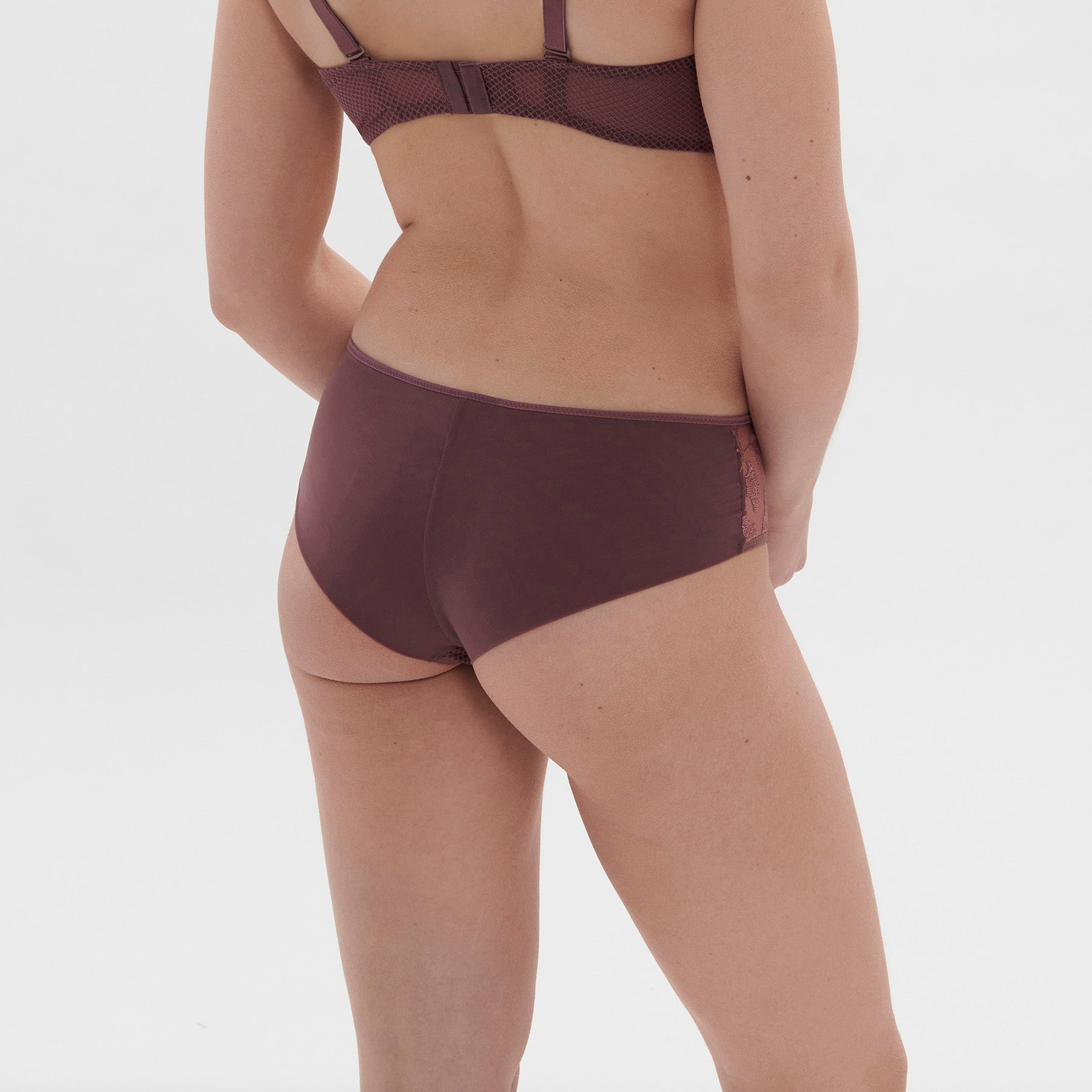 Mid rise shorty boyshort with embroidered side details in burgundy purple byzantine. Rear view on model.