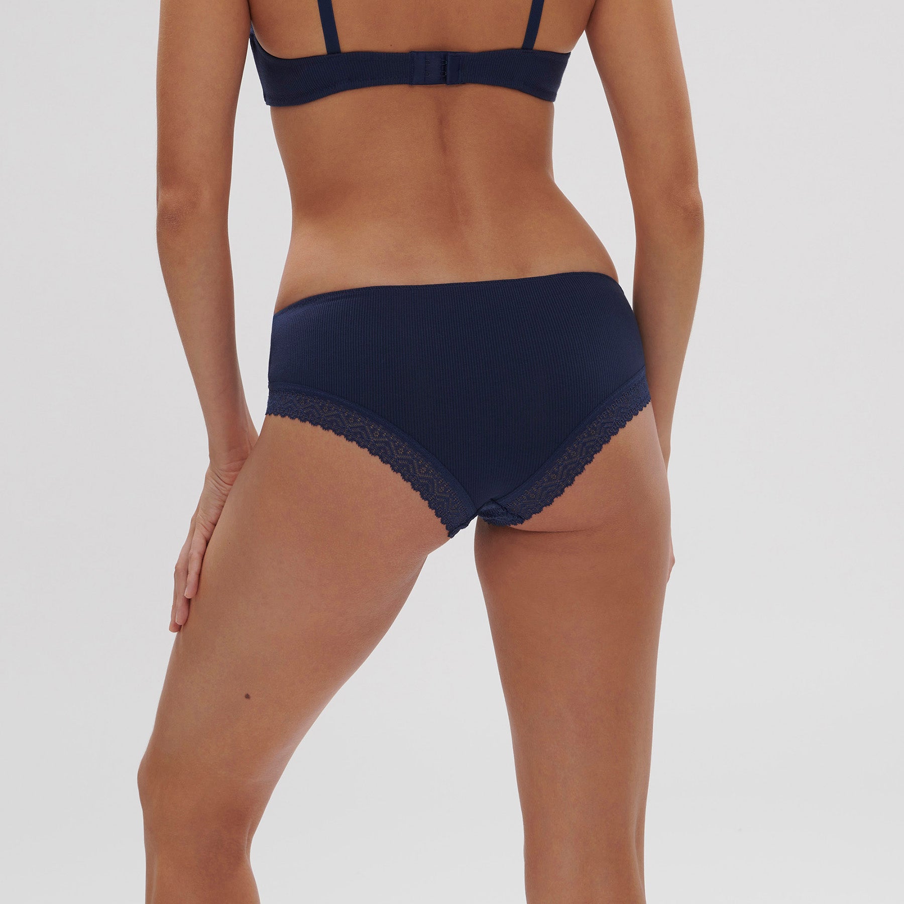 Boyshort in dark blue navy in ribbed fabric on model, rear view.