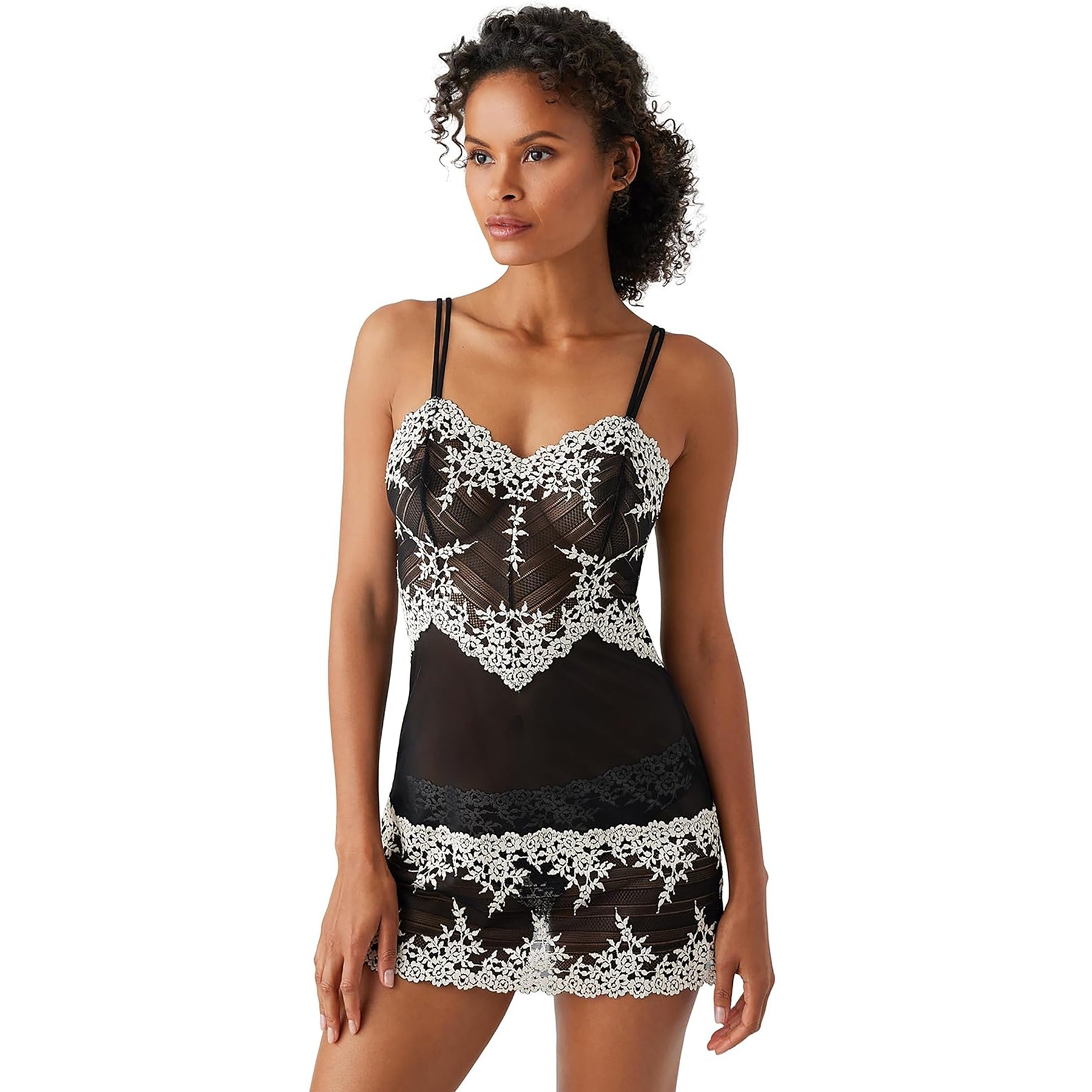 Spaghetti strap sheer black mesh chemise with cream lace embroidery details on model front view