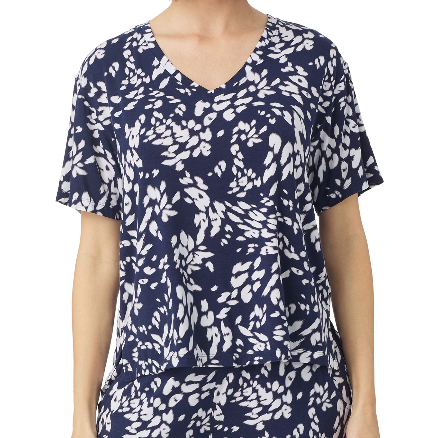 A close-up of the pajama top, highlighting its relaxed fit, V-neckline, and short sleeves with a botanical print.