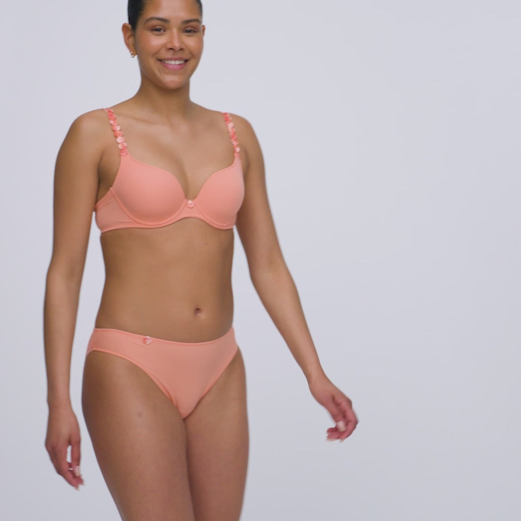 Seamless rio bikini brief in papaya smoothie light orange, shown with matching heart shaped bra on model.